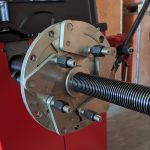 Universal flange plate adapter with adjustable studs on a wheel balancing machine